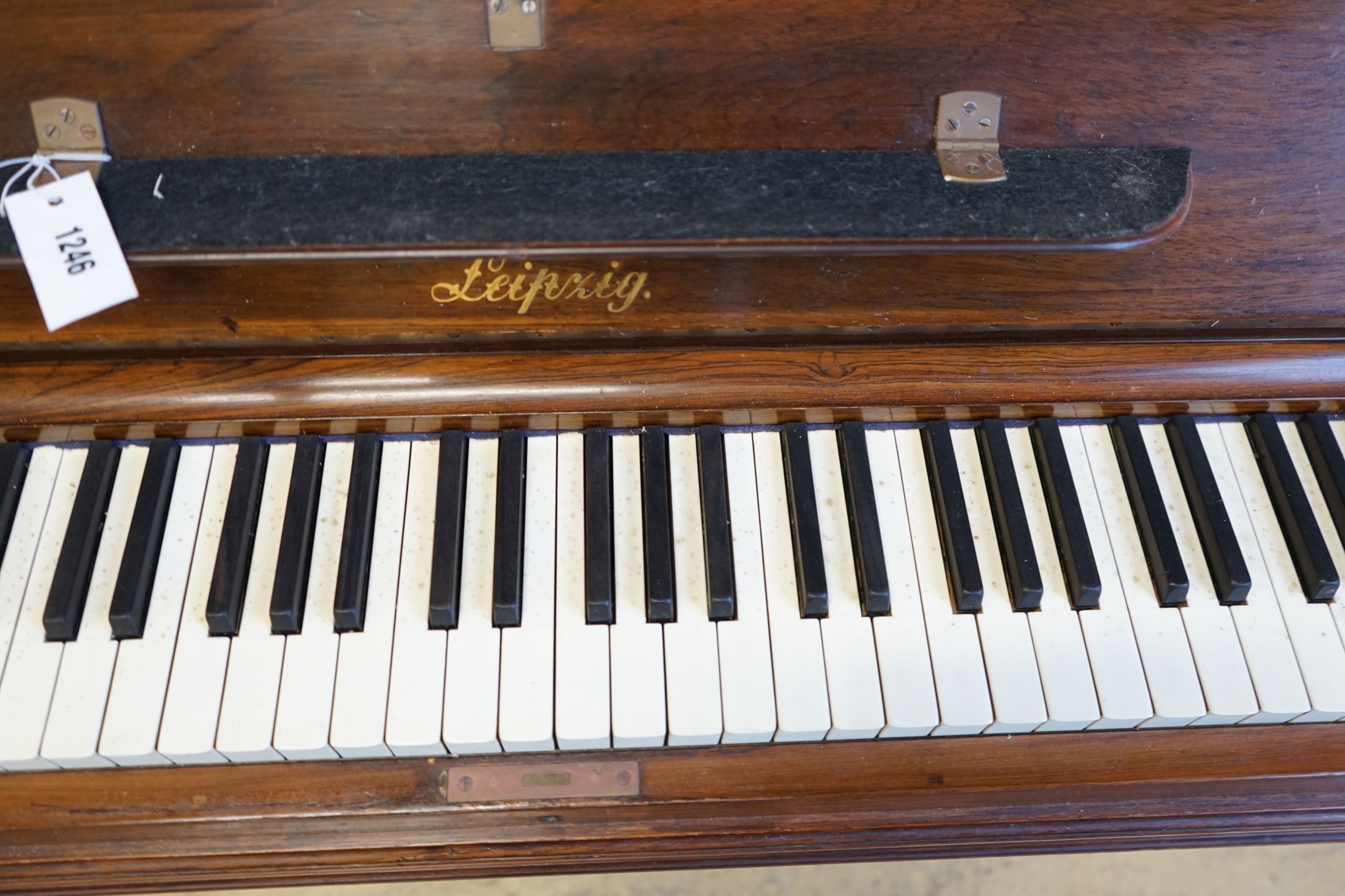 An early 20th century walnut cased Bluthner upright piano, Serial Number 92280